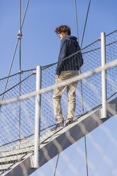 Germany, Stuttgart, Teenage boy standing on stairs of Killesberg Tower - WDF002419