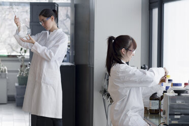 Two young female chemistry students in lab - SGF000480