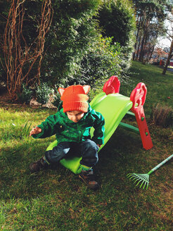 little boy with red hat slips on the slide, Potsdam, Germany - AFF000049