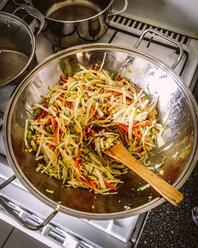 Preparing wok dish with cabbage, carrots and spring onions - EVGF000473