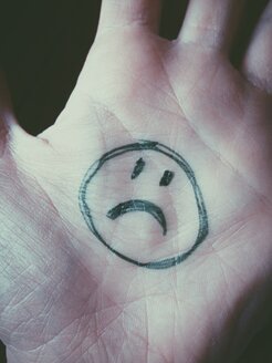 Sad Smiley on hand in office - MEAF000224