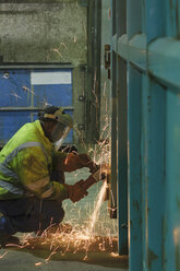 Mann arbeitet an einem Container in einer Schrottverwertungsanlage - LAF000813