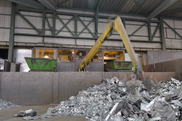 Greifer, der Aluminiumbrocken in einer Schrottrecyclinganlage auffängt - LAF000844