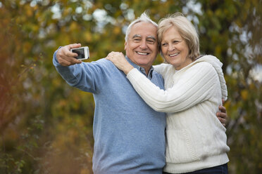 Portrait of happy senior couple taking self-portrait with smartphone - WESTF019213