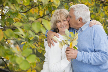 Portrait of senior kissing his wife - WESTF019223