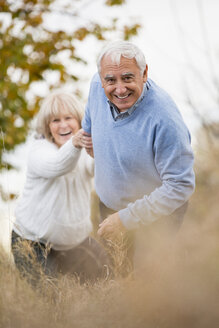 Smiling senior couple on the move - WESTF019226