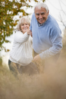 Smiling senior couple on the move - WESTF019227