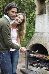 Couple having a barbecue - ABF000538