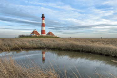 Germany, Schleswig-Holstein, North Sea Coast, View of Westerheversand Lighthouse in the evening - RJ000060