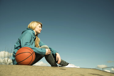 Germany, Mannheim, Young woman with medicine ball at skate park - UUF000023