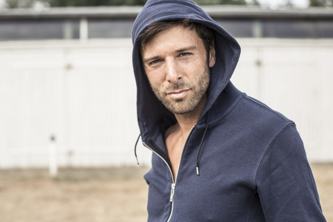 Portrait of man wearing hooded jacket stock photo