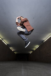 Young breakdancer jumping in the air in underpass - STSF000392