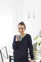 Portrait of young woman with mug at home - EBSF000125