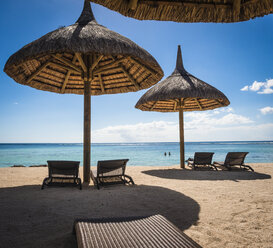 Mauritius, sunshades and beach chairs in front of the sea - DISF000695