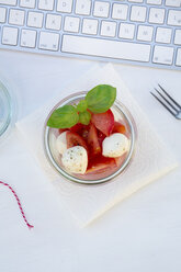 Mini-Mozzarella mit Tomaten und Basilikum im Glas auf dem Tisch - LVF000966