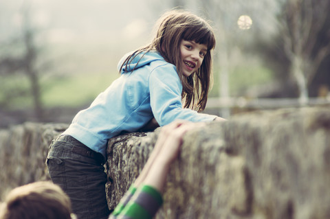 Portrait of girl climbing on wall stock photo