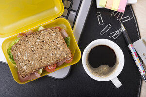 Arbeitsplatz mit Lunchbox und Tasse Kaffee - CSTF000214