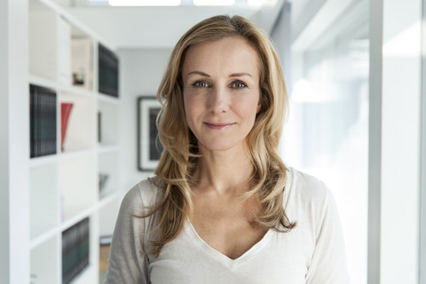 Portrait of woman in her bright modern home stock photo