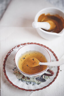Cup of turmeric tea spiced with pepper - SBDF000749