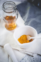 Turmeric in mortar and glas of honey for preparation turmeric tea - SBDF000768