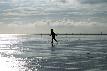 Germany, Schleswig-Holstein, Sankt Peter-Ording, North Sea, boy running at beach - JEDF000183