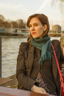 Germany, Berlin, female tourist sitting at cafe near Spree River - FBF000314