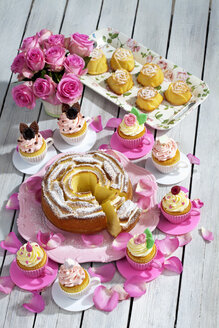 Geburtstagskuchen, Cupcakes, Muffins und Blumenvase mit rosa Rosen auf Holztisch - CSF021210
