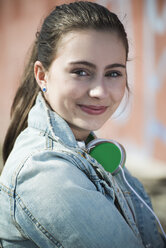 Porträt eines lächelnden Teenagers mit Kopfhörern - UUF000191