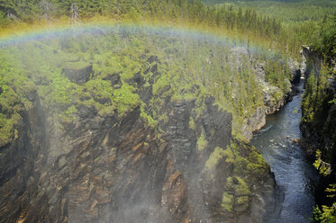 Sweden, Gaeddede, Rainbow at waterfall Haellingsafallet - BR000304