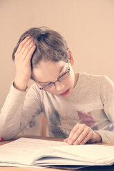 Portrait of little boy doing homework - LVF001038