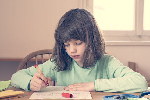 Portrait of little girl doing homework - LVF001041