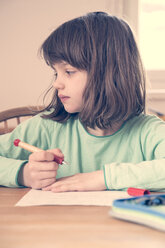 Portrait of little girl doing homework - LVF001042