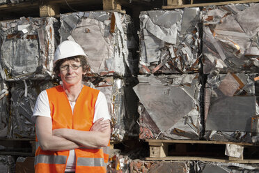 Portrait of female technician at recycling yard of aluminium - SGF000549