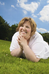 Germany, Duisburg, Mid-adult woman relaxing in meadow - ECF000557