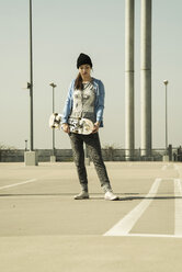Young woman with skateboard on parking level - UUF000220