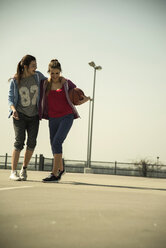 Two young women with basketball outdoors - UUF000242