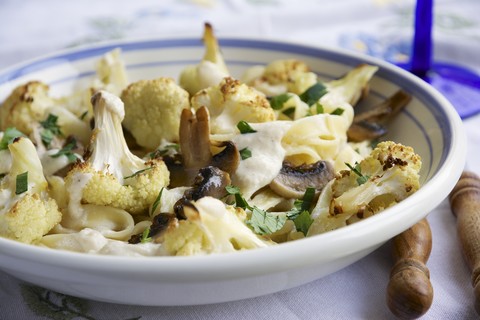 Pasta Alfredo with roasted Cauliflower and Mushrooms stock photo