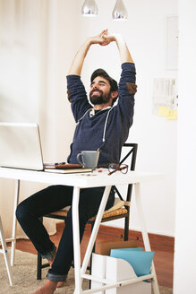 Man stretching at modern home office - EBSF000172