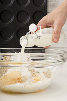 Pouring buttermilk to dough for Whoopie pies - CSTF000267