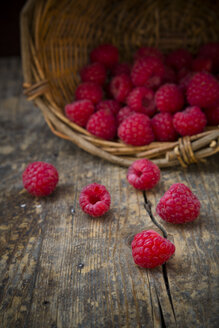 Basket of raspberries on wooden table - LVF001065