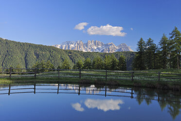 Italy, Trentino-Alto Adige, Dolomites, Latemar mountains reflecting in lake - RUEF001250