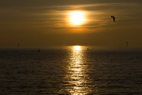 Deutschland, Niedersachsen, Wremen, Nordsee, Kite-Surfer bei Sonnenuntergang - SJF000103