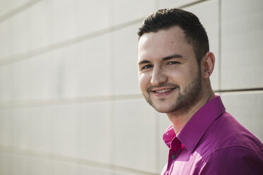 Portrait of smiling man wearing pink shirt - UUF000314