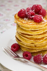 Stack of pancakes with honey, raspberries and icing sugar - LVF001097