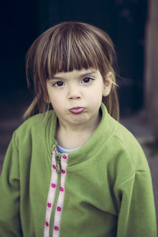 Portrait of little girl pouting mouth stock photo