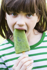 Portrait of girl with kiwi ice lolly - LVF001112