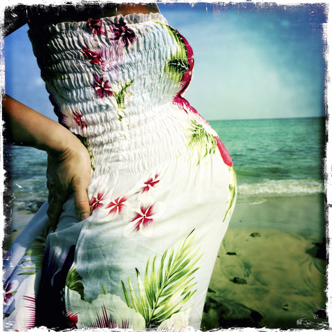 Pregnant woman standing on the Beach, Fuerteventura, Spain stock photo