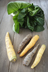 Chinese cabbage and different sorts of carrots on wooden table - EVGF000542