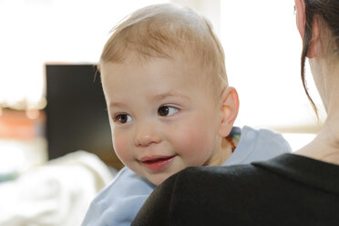 Mother holding smiling baby boy - LAF000790