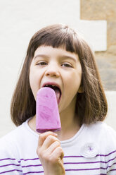 Portrait of little girl with yoghurt blueberry ice lolly - LVF001127